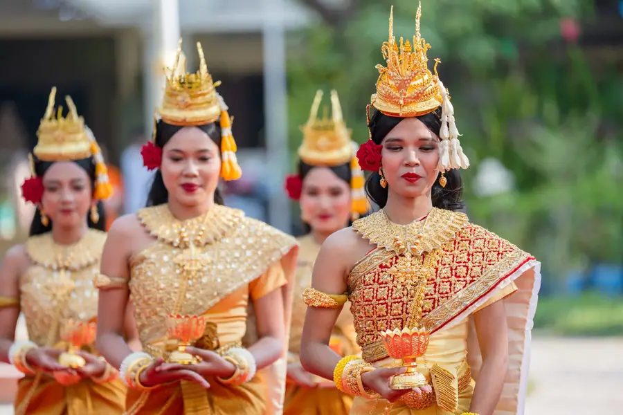 Festival devotee with flower garlands and red tassels in a street procession